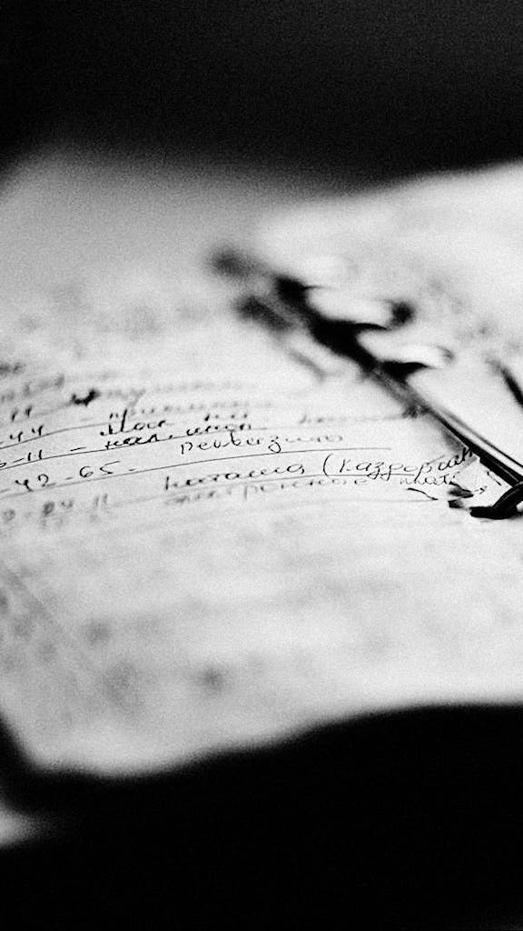 Elegant black and white photo depicting handwritten notes in a notebook with fine detail.
